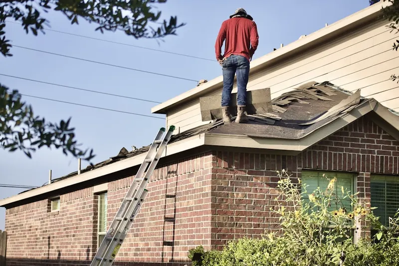 Professional roofer working on a residential roof in Rondout